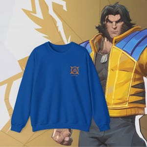 May include: A royal blue sweatshirt with a small orange graphic of a circle with a cross inside. The text "Unbreakable" is written below the graphic.