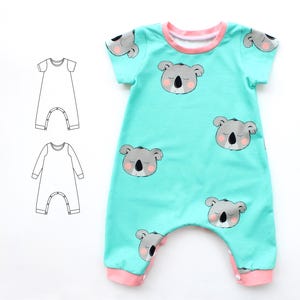 May include: A turquoise baby romper with a repeating pattern of sleeping koala faces. The romper has short sleeves, a pink neckline, and pink cuffs. Two line drawings of romper patterns are on the left.