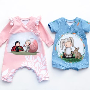 Op de afbeelding: Twee babyrompers. Eén is roze met een lieveheersbeestje en slakkenafbeelding, de andere is blauw met een konijnenafbeelding. Beide hebben een wikkelontwerp en zijn gemaakt van zachte stof. De roze romper heeft lange mouwen, de blauwe heeft korte mouwen.
