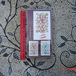 May include: A vintage playing card set with a floral design. The box is brown with a white border and the text "Bridge" in a white banner. The cards are in three colors: red, blue, and green.