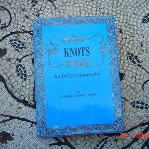 May include: A blue book with a silver border and the title "KNOTS useful & ornamental" by GEORGE RUSSELL SHAW.