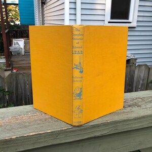 May include: A yellow hardcover book titled "The Complete Nonsense of Edward Lear" by Holbrook Jackson. The book is published by Dover.