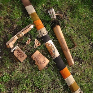 Archery Leather Set Of A Hand Tooled Back Quiver, A Belt, A Belt Pouch, An Arm Guard, A Finger Tab And A Bow Sock