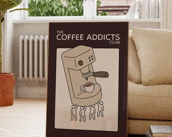 May include: A brown and beige poster with the text "The Coffee Addicts Club" and a cartoon illustration of a coffee maker with people holding it up. The poster is hanging on a white wall in a living room with a couch, a plant, and a chair.