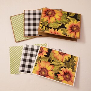 May include: Set of four blank greeting cards featuring a sunflower design with black and white gingham and green patterned paper.