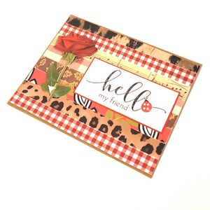 May include: A handmade greeting card with a red rose and the words "hello my friend" in elegant script. The card features a collage of patterned papers, including gingham, floral, and animal print designs.