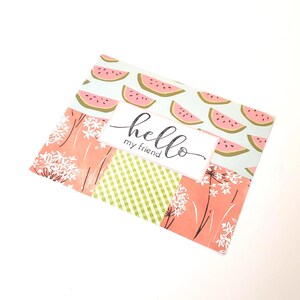 May include: A greeting card with a patchwork design featuring watermelon slices, floral patterns, and green gingham. The card has the words "hello my friend" in elegant script.