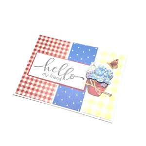 May include: A greeting card with a patchwork design featuring red gingham, blue polka dots, and yellow gingham patterns. The card says "hello my friend" in cursive. A flower pot and butterfly are also featured.