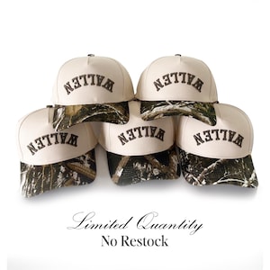 May include: A stack of six baseball caps with a cream-colored crown and a camouflage brim. The word "WALLEN" is embroidered in dark brown on the front of each cap. The text "Limited Quantity No Restock" is below the caps.