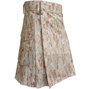 May include: A beige and brown camouflage kilt with two cargo pockets on the left side. The kilt has a wrap-around design with a buckle closure at the waist. The fabric has a pixelated pattern.
