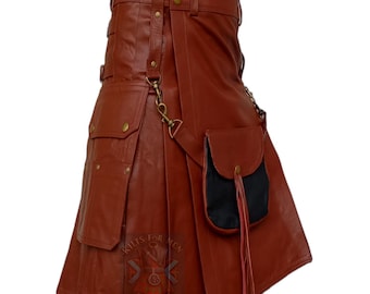 May include: A rust-colored kilt featuring a high waistband with gold-toned buttons, multiple cargo-style pockets with flaps, and a detachable black pouch suspended by a gold-toned metal chain and clip. The garment has vertical pleats and straps.