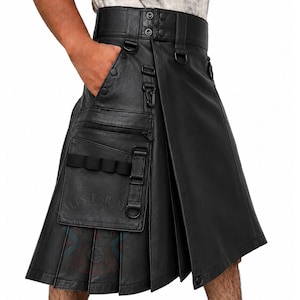 May include: A black leather kilt featuring a high waistband with snap closures, multiple D-rings, and a large cargo pocket on the front. The pocket includes a horizontal zipper, a vertical strap, and a row of four elastic loops for storage.
