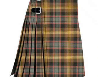 May include: A traditional kilt in a brown, yellow, red, and gray plaid pattern. The kilt features pleats and two black leather straps with silver buckles for closure. The fabric has a textured appearance.