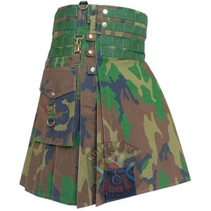 May include: A camouflage kilt with a green waistband and accents. The kilt features a pocket on the left side and metal hardware. The fabric has a pattern of green, brown, and navy blue. The text "Kilts for Men" is visible.