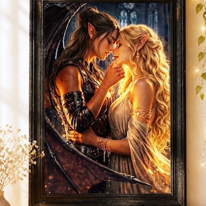 May include: A framed art print depicts two figures in an embrace, with one figure having dark wings. The artwork features a fantasy theme with soft lighting and a detailed background. The frame is black, and the print is displayed on a white surface with books and a candle.