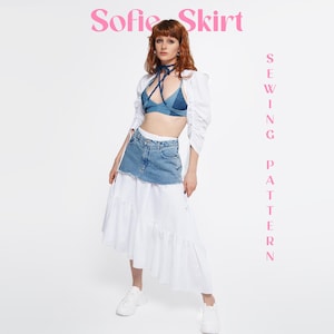 May include: A Sofie Skirt sewing pattern featuring a layered garment with a blue denim mini skirt top section and a long white tiered skirt bottom. The outfit includes a blue denim bralette with tie straps and a white long-sleeved bolero top.