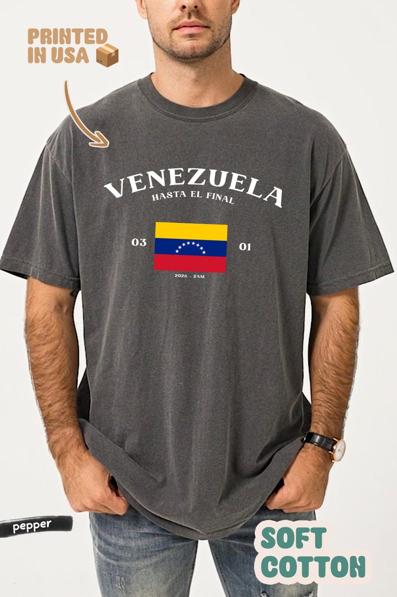 May include: Dark gray t-shirt with the word "VENEZUELA" in white, and the phrase "HASTA EL FINAL" above a Venezuelan flag graphic. The shirt also has the text "03 01" and "2020 - ZAM". The shirt is made of soft cotton.