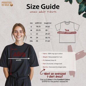 May include: A woman wearing a black t-shirt, with a size guide for unisex adult t-shirts. The guide lists sizes S to 2XL, with width and length measurements in inches. The shirt is heavyweight, made of ring-spun cotton, and has a relaxed fit.