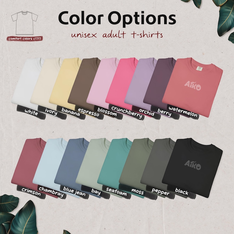 May include: A display of unisex adult t-shirts in various colors, including white, ivory, banana, espresso, blossom, crunchberry, orchid, berry, watermelon, crimson, chambray, blue jean, bay, seafoam, moss, pepper, and black. The text "Color Options" and "unisex adult t-shirts" are visible.