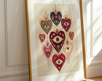 May include: A framed art print featuring a collection of embroidered hearts with eye designs. The hearts are in shades of red, pink, green, and blue, with gold and cream accents. The artwork is displayed in a wooden frame.