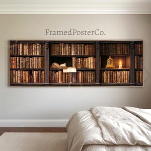 May include: A panoramic wall art print featuring a dark wooden bookshelf filled with rows of aged, leather-bound books. The display includes an open book on a shelf and a small gold clock next to a lit candle. The text FramedPosterCo. is visible.