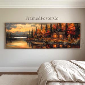 May include: A panoramic landscape painting titled FramedPosterCo. featuring a log cabin by a lake during autumn. The scene displays vibrant orange and red trees, a small wooden boat near the shore, and a golden sunset sky with birds in flight.