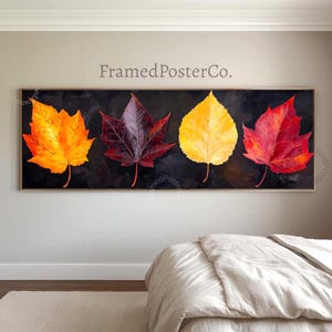 May include: A panoramic wall art print featuring four distinct autumn leaves arranged horizontally against a dark black background. The leaves are colored in vibrant shades of orange, deep burgundy, bright yellow, and red, showcasing detailed veins.