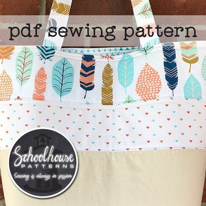 May include: A PDF sewing pattern for a tote bag with a white background and colorful feather print. The bag has a brown canvas bottom and a white fabric with small blue and red triangles. The pattern is from Schoolhouse Patterns, with the tagline "Sewing is always in session".