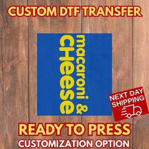 May include: A blue square with yellow text that reads "macaroni & Cheese". The image also includes the text "CUSTOM DTF TRANSFER", "READY TO PRESS", and "CUSTOMIZATION OPTION". A red square with the words "NEXT DAY SHIPPING" is also present.