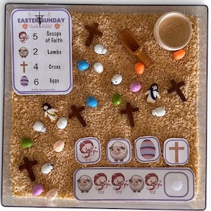 May include: An Easter-themed sensory bin with rice, wooden crosses, colorful eggs, and small figurines of Jesus and lambs. Includes a card with the text "Easter Sunday He Is Risen" and counting prompts. A fun, educational activity.
