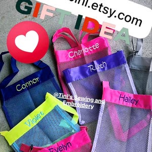 May include: Colorful mesh shell bags with personalized names embroidered on them. The bags have different colored trim and handles. The image includes the text "GIFT IDEA" and "Shell Bags make great little personalized gift bags."