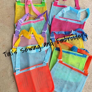 May include: Assortment of colourful mesh bags with zippered pockets and adjustable straps. The bags are made of a fine mesh material and are perfect for carrying small items.