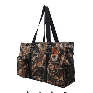 May include: A large, black and brown camouflage tote bag with multiple pockets and a mesh side pocket. The bag has two long black handles.