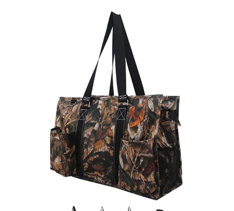 May include: A large, black and brown camouflage tote bag with multiple pockets and a mesh side pocket. The bag has two long black handles.