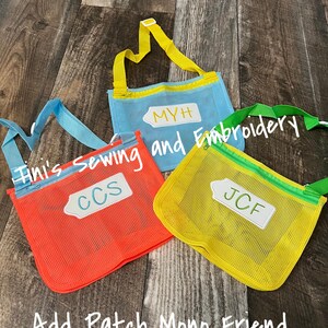 May include: Three mesh bags with zipper closures and adjustable straps. The bags are in different colours: orange, blue, and yellow. Each bag has a white rectangular tag with a name on it: CCS, MYH, and JCF. The text "Tini's Sewing and Embroidery" is written in white on a blue bag. The text "Add Patch Mono Friend" is written in white on a wooden surface.