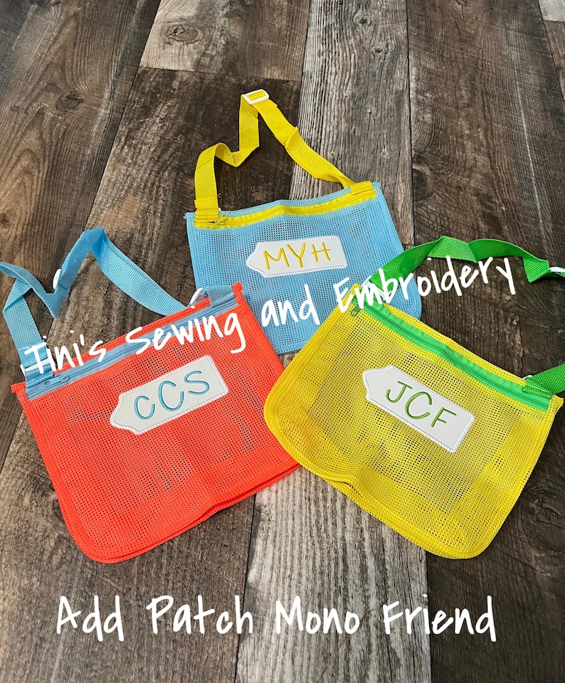 May include: Three mesh bags with zipper closures and adjustable straps. The bags are in different colours: orange, blue, and yellow. Each bag has a white rectangular tag with a name on it: CCS, MYH, and JCF. The text "Tini's Sewing and Embroidery" is written in white on a blue bag. The text "Add Patch Mono Friend" is written in white on a wooden surface.