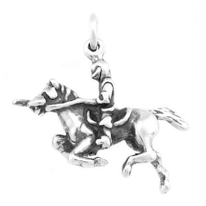 May include: A silver charm depicting a rider on horseback, the horse is rearing up on its hind legs, the rider is holding a lance, the charm is suitable for use on a bracelet or necklace.