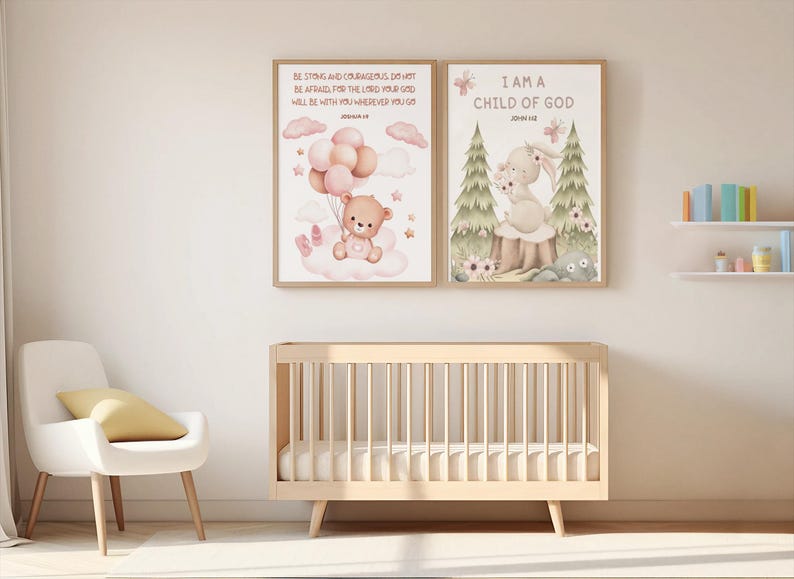 Side-by-side framed nursery prints on a pink wall: one with a bunny and John 1:12, the other with a teddy bear and Joshua 1:9. Displayed on top of the baby crib and white chair.