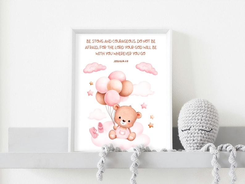 Framed teddy bear scripture art featuring Joshua 1:9 displayed on a white shelf with a gray crocheted octopus plushie, showing ideal placement in a baby’s nursery decor.