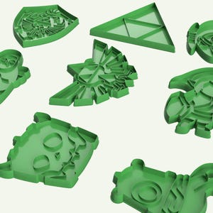 May include: Set of nine green plastic cookie cutters shaped like various video game characters and symbols.