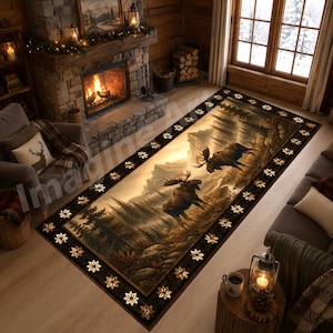 May include: A rectangular area rug featuring a mountain landscape with two moose. The rug has a dark brown border with floral accents. The central image depicts a forest and mountains in shades of brown and tan.