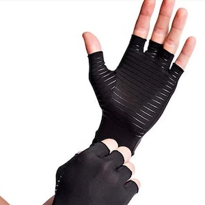 May include: A white ceramic mug with a black handle and the text "But First, Coffee" in a bold, black font. The mug is set against a blurred background, suggesting a cozy setting.