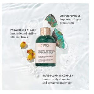 May include: A green glass bottle of Biossance Squalane + Copper Peptide Rapid Plumping Serum. The bottle is sitting on a white surface with green and blue stones. The text on the bottle reads "Biossance Squalane + Copper Peptide Rapid Plumping Serum". The text on the bottle also reads "Paracress Extract Instantly and visibly lifts and firms" and "Copper Peptides Support collagen production".