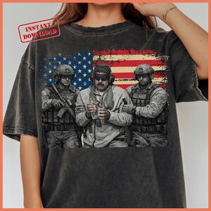 May include: Dark gray t-shirt featuring a graphic of three U.S. Navy personnel in front of a distressed American flag. The shirt includes the text "INSTANT DOWNLOAD" in a red stamp.