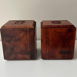 May include: Two dark brown wooden storage boxes with lids. One box is labelled "SUCRE SUGAR" and the other "FARINE FLOUR". Each lid has a circular opening. The boxes are designed for kitchen storage.