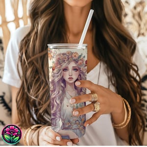 May include: A stainless steel tumbler with a colorful floral design featuring a woman with long blonde hair wearing a flower crown. The tumbler has a clear lid and a straw.