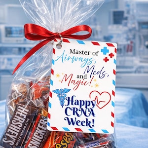May include: A clear cellophane gift bag tied with a red ribbon, filled with assorted chocolate bars. A tag with the words "Master of Airways, Meds, and Magic! Happy CRNA Week!" is attached to the bag.
