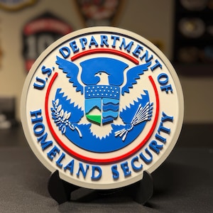 May include: A white ceramic mug with a black handle and the text "But First, Coffee" in a handwritten style. The mug is on a white surface. The mug is approximately 4 inches tall.