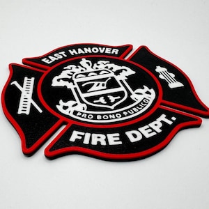 May include: Black and red firefighter emblem with the words "East Hanover Fire Dept." and the text "Pro Bono Publico" in a white shield.