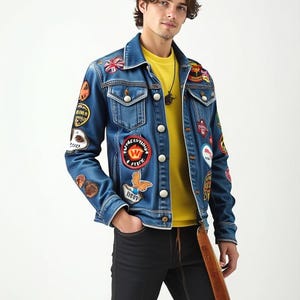 May include: A blue denim jacket with multiple colorful patches, including a peace sign, a butterfly, and a crown. The jacket has a yellow button closure and is worn over a yellow t-shirt.